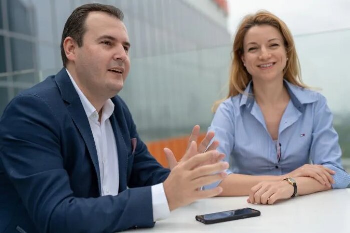 Deux collaborateurs discutant ensemble en extérieur, illustrant un projet d’entreprise visant à renforcer l’engagement et la cohésion interne.