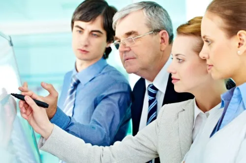 Team of consultants analyzing technical plans for a high-speed network project aimed at remote areas.